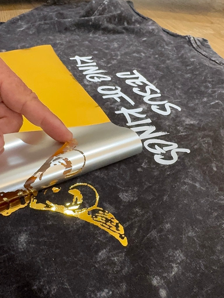 gold foil transfer being applied to a shirt
