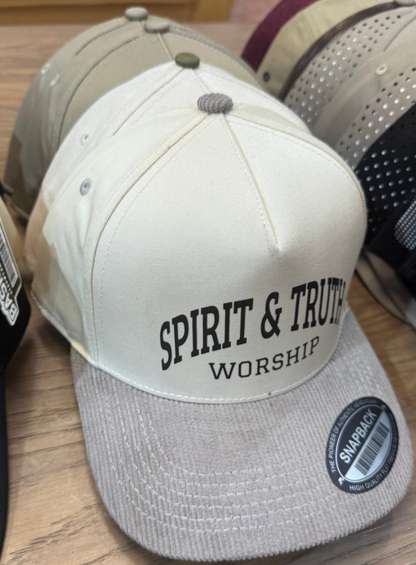 Collection of baseball caps with visible branding on a wooden surface