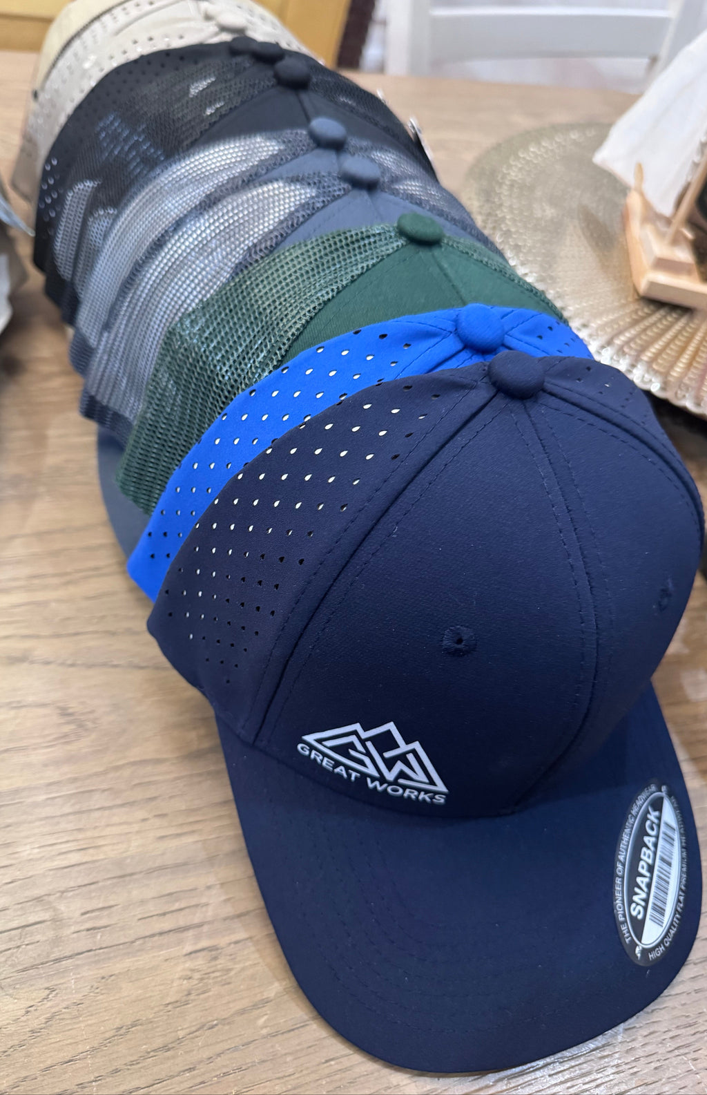 Blue cap with a logo on a wooden surface